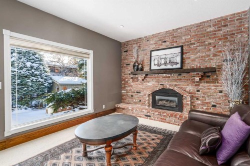215 Edgemont Place Nw, Calgary, AB - Indoor Photo Showing Living Room With Fireplace
