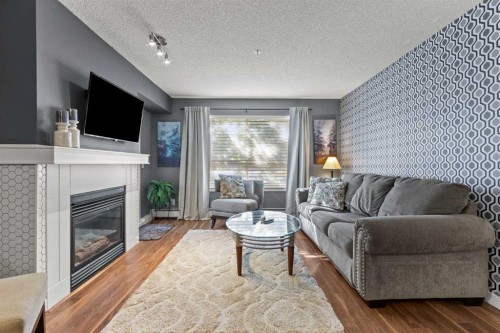 116-5115 Richard Road Sw, Calgary, AB - Indoor Photo Showing Living Room With Fireplace