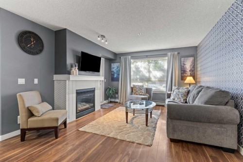 116-5115 Richard Road Sw, Calgary, AB - Indoor Photo Showing Living Room With Fireplace