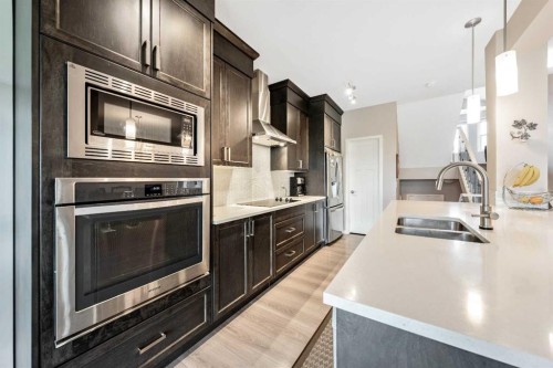 75 Fireside Crescent, Cochrane, AB - Indoor Photo Showing Kitchen With Double Sink With Upgraded Kitchen
