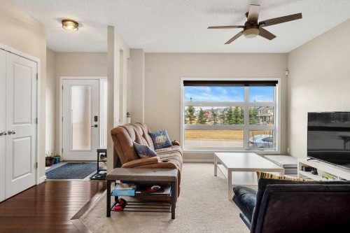 24 Copperpond Park Se, Calgary, AB - Indoor Photo Showing Living Room