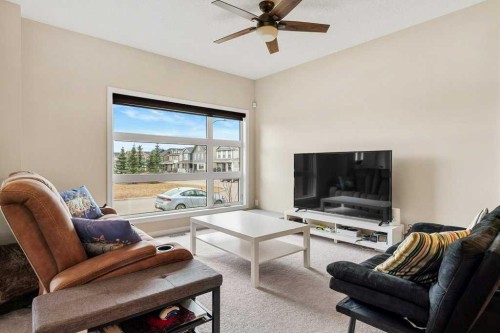 24 Copperpond Park Se, Calgary, AB - Indoor Photo Showing Living Room
