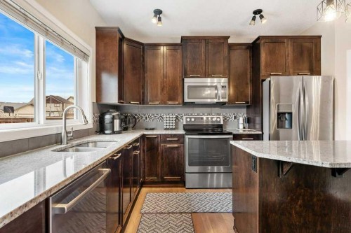 24 Copperpond Park Se, Calgary, AB - Indoor Photo Showing Kitchen With Stainless Steel Kitchen With Double Sink With Upgraded Kitchen