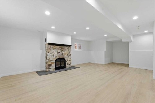 128 Deermoss Crescent Se, Calgary, AB - Indoor Photo Showing Other Room With Fireplace