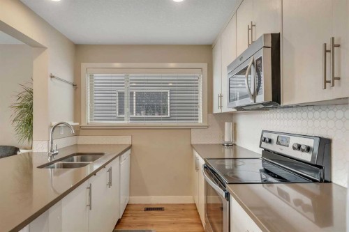 201-50 Belgian Lane, Cochrane, AB - Indoor Photo Showing Kitchen With Double Sink