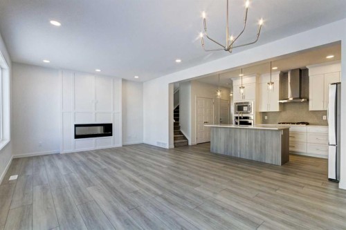52 Magnolia Green Se, Calgary, AB - Indoor Photo Showing Kitchen With Fireplace With Upgraded Kitchen