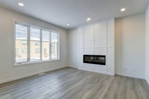 52 Magnolia Green Se, Calgary, AB - Indoor Photo Showing Living Room With Fireplace