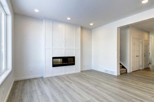52 Magnolia Green Se, Calgary, AB - Indoor Photo Showing Other Room With Fireplace