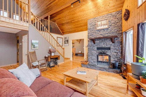 51 Manyhorses Drive, Rural Rocky View County, AB - Indoor Photo Showing Living Room With Fireplace