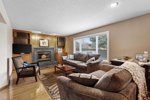 1208 Sunvista Way Se, Calgary, AB - Indoor Photo Showing Living Room With Fireplace