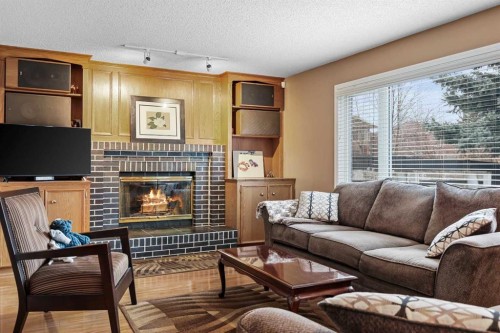 1208 Sunvista Way Se, Calgary, AB - Indoor Photo Showing Living Room With Fireplace
