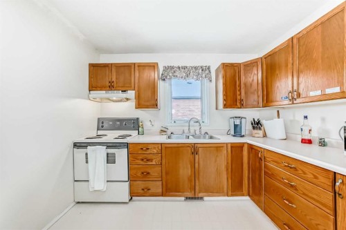220 Haskayne Avenue, Gleichen, AB - Indoor Photo Showing Kitchen With Double Sink