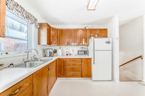 220 Haskayne Avenue, Gleichen, AB - Indoor Photo Showing Kitchen With Double Sink