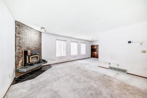 11 Falwood Place Ne, Calgary, AB - Indoor Photo Showing Other Room With Fireplace