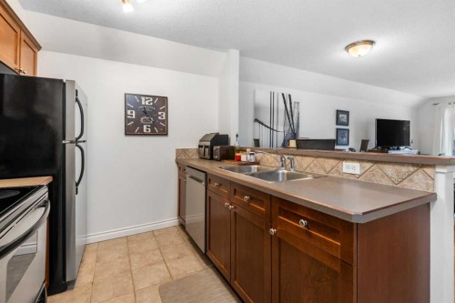 106-420 3 Avenue Ne, Calgary, AB - Indoor Photo Showing Kitchen With Double Sink