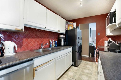 11 Ridgebrook Drive Sw, Airdrie, AB - Indoor Photo Showing Kitchen With Double Sink