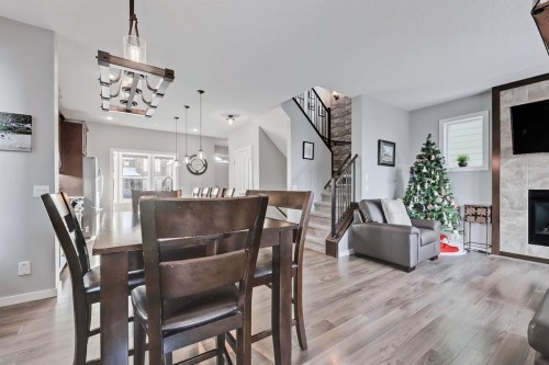 300 Marquis Heights Se, Calgary, AB - Indoor Photo Showing Dining Room With Fireplace