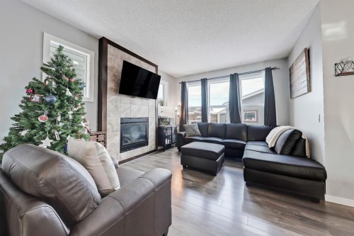 300 Marquis Heights Se, Calgary, AB - Indoor Photo Showing Living Room With Fireplace