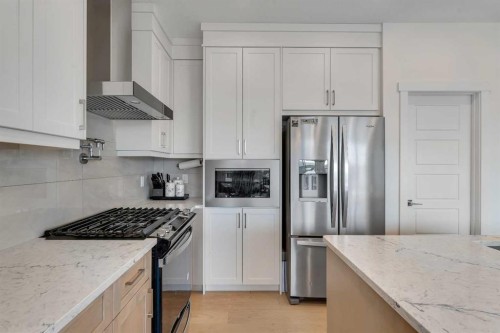 172 Precedence Hill, Cochrane, AB - Indoor Photo Showing Kitchen With Upgraded Kitchen