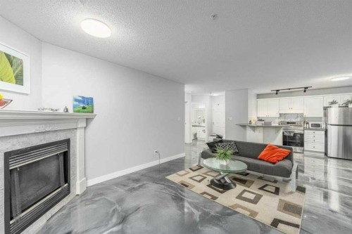 109-777 3 Avenue Sw, Calgary, AB - Indoor Photo Showing Living Room With Fireplace