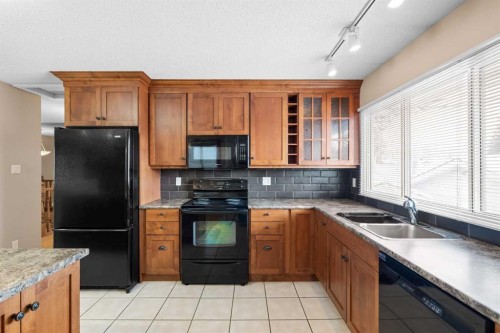 10727 Mapleglen Crescent Se, Calgary, AB - Indoor Photo Showing Kitchen With Double Sink