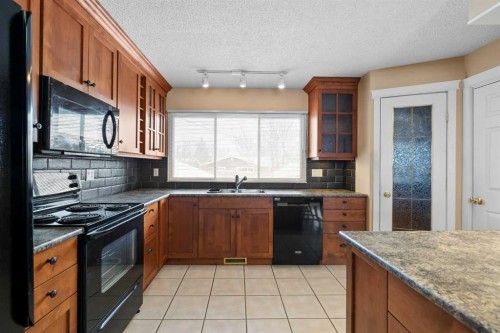 10727 Mapleglen Crescent Se, Calgary, AB - Indoor Photo Showing Kitchen With Double Sink