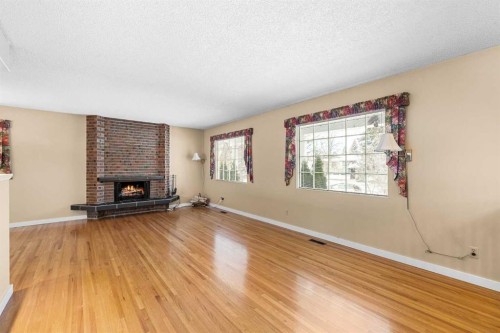 10727 Mapleglen Crescent Se, Calgary, AB - Indoor Photo Showing Living Room With Fireplace