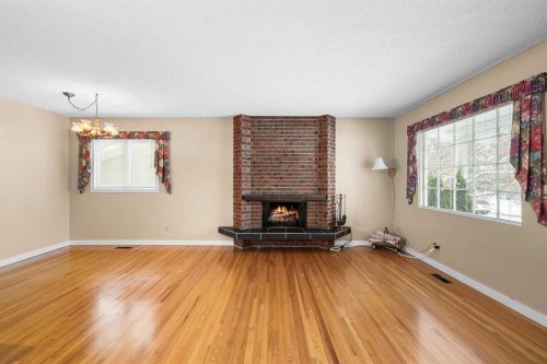 10727 Mapleglen Crescent Se, Calgary, AB - Indoor Photo Showing Living Room With Fireplace