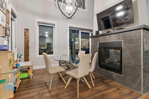 163 Masters Cove Se, Calgary, AB - Indoor Photo Showing Dining Room With Fireplace