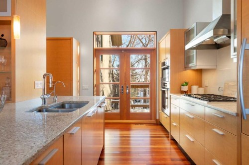 211 Coach Side Road Sw, Calgary, AB - Indoor Photo Showing Kitchen With Double Sink With Upgraded Kitchen