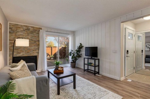 308-13104 Elbow Drive Sw, Calgary, AB - Indoor Photo Showing Living Room With Fireplace