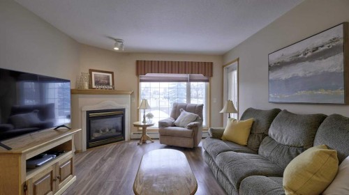 211-728 Country Hills Road Nw, Calgary, AB - Indoor Photo Showing Living Room With Fireplace