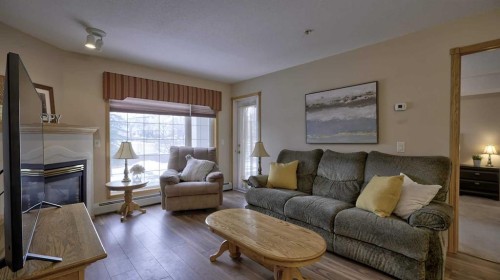 211-728 Country Hills Road Nw, Calgary, AB - Indoor Photo Showing Living Room With Fireplace