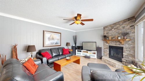 5313 50 Street, Stavely, AB - Indoor Photo Showing Living Room With Fireplace