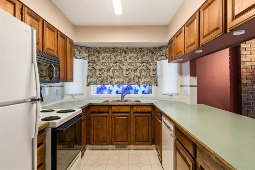 716 Coach Bluff Crescent Sw, Calgary, AB - Indoor Photo Showing Kitchen With Double Sink