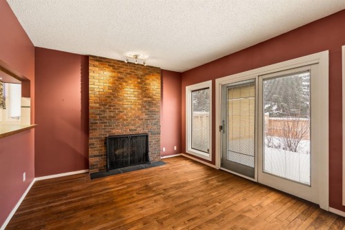 716 Coach Bluff Crescent Sw, Calgary, AB - Indoor Photo Showing Other Room With Fireplace