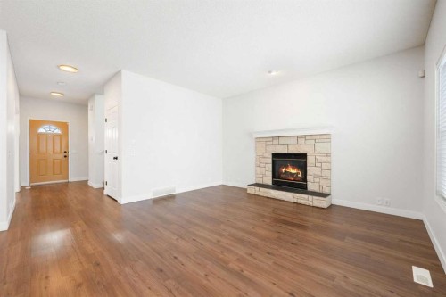 283 Prestwick Landing Se, Calgary, AB - Indoor Photo Showing Living Room With Fireplace