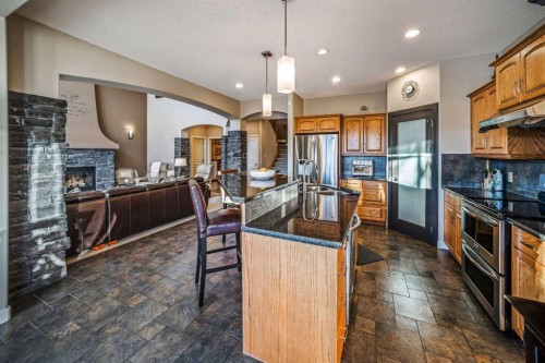 74 Sherwood Point Nw, Calgary, AB - Indoor Photo Showing Kitchen With Fireplace With Upgraded Kitchen