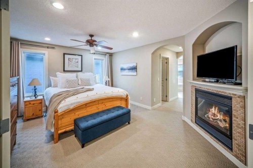 74 Sherwood Point Nw, Calgary, AB - Indoor Photo Showing Bedroom With Fireplace