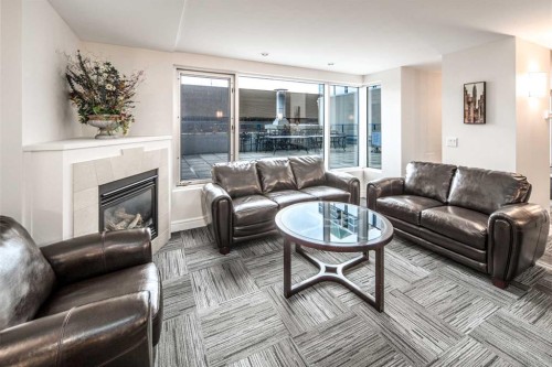 1907-920 5 Avenue Sw, Calgary, AB - Indoor Photo Showing Living Room With Fireplace