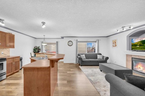 105 Covemeadow Bay Ne, Calgary, AB - Indoor Photo Showing Kitchen With Fireplace