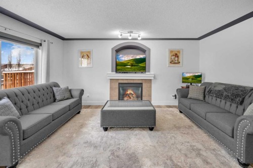 105 Covemeadow Bay Ne, Calgary, AB - Indoor Photo Showing Living Room With Fireplace