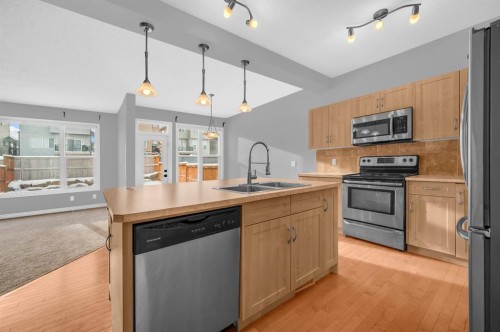 402 Hillcrest Circle Sw, Airdrie, AB - Indoor Photo Showing Kitchen With Double Sink