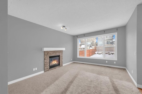 402 Hillcrest Circle Sw, Airdrie, AB - Indoor Photo Showing Living Room With Fireplace