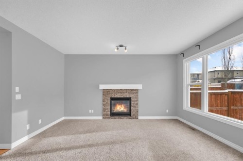402 Hillcrest Circle Sw, Airdrie, AB - Indoor Photo Showing Living Room With Fireplace