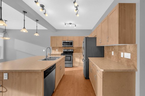 402 Hillcrest Circle Sw, Airdrie, AB - Indoor Photo Showing Kitchen With Double Sink
