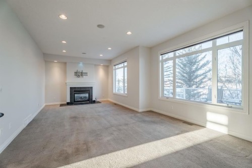 14 Discovery Woods Villas Sw, Calgary, AB - Indoor Photo Showing Living Room With Fireplace