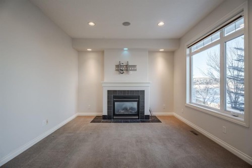 14 Discovery Woods Villas Sw, Calgary, AB - Indoor Photo Showing Living Room With Fireplace