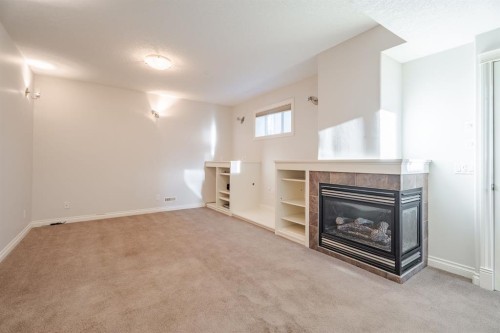 14 Discovery Woods Villas Sw, Calgary, AB - Indoor With Fireplace
