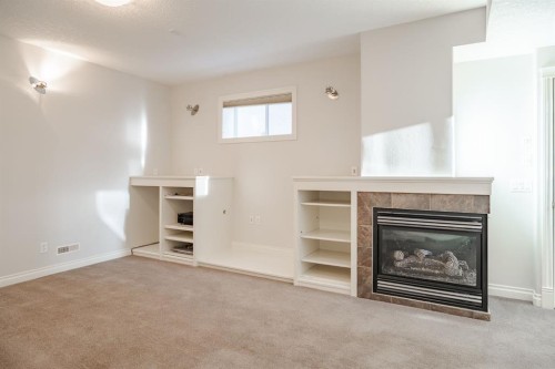 14 Discovery Woods Villas Sw, Calgary, AB - Indoor With Fireplace